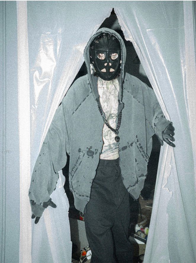 Dystopia campaign, masked figure between plastic curtains