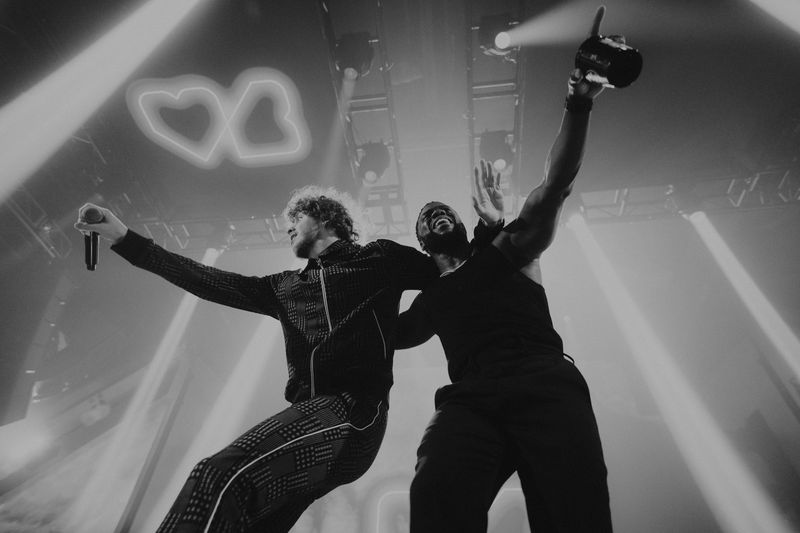 Jack Harlow and Kevin Hart on stage at a HartBeat event